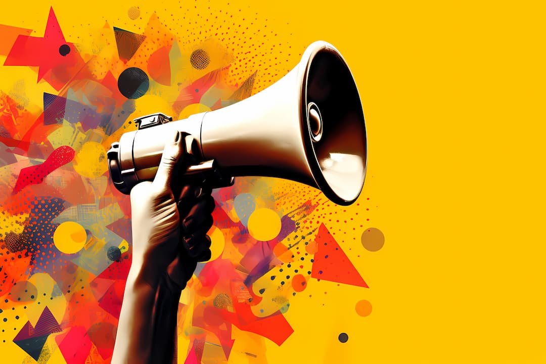 Megaphone Held Up On A Bright Yellow Background