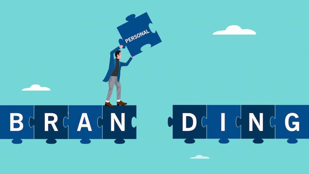 a guy putting a puzzle piece with personal written on into other puzzle pieces that say branding